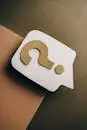 Artistic paper craft of a question mark on neutral background. Ideal for concept themes.